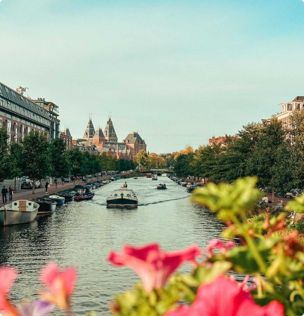 Amsterdam canal with boats and flowers